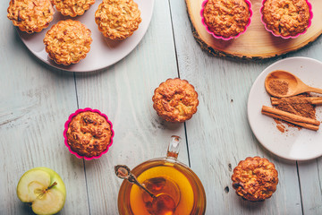 Oatmeal muffins with apple and cup of green tea.