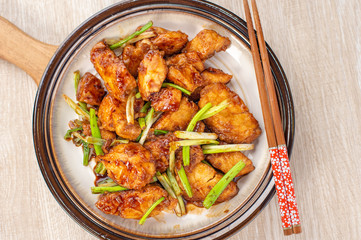 Delicious homemade stewed fish slices with scallion in wooden background, Taiwan delicacies, top view, copy space