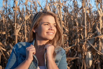 Beautiful young blond-haired woman is having fun in corn field - Powered by Adobe