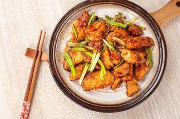 Delicious homemade stewed fish slices with scallion in wooden background, Taiwan delicacies, top view, copy space