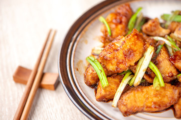 Delicious homemade stewed fish slices with scallion in wooden background, Taiwan delicacies, top view, copy space