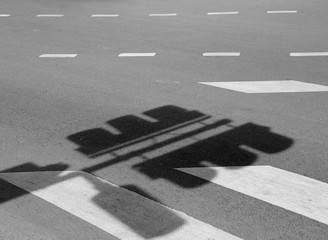 Fototapeta premium shadow of Traffic light pole on road