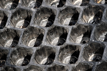 Empty plastic plant pots and seeding containers. Closeup image