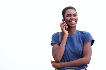 happy young african american woman talking on cellphone against white background