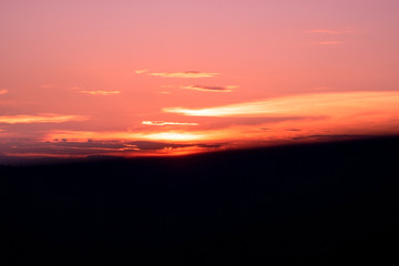 purple orange sky and sunlight and Silhouette black Long mountain in evening time