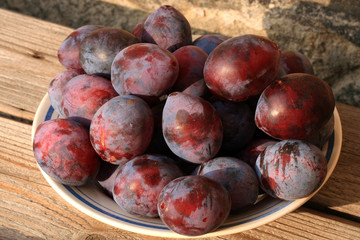 Plums from home orchard. Tasty and healthy snack on the farm. Set of fruits in the countryside.