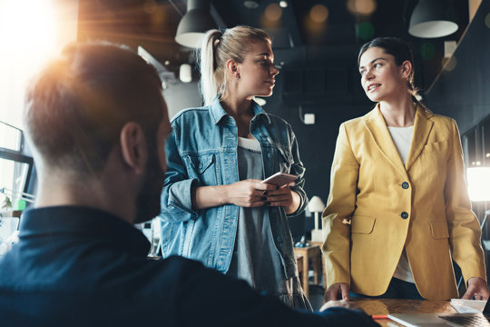Group of managing partners discussing company strategy with chief