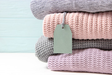 a pile of warm sweaters. Warm clothes. Sweaters in the store. Sale, tag