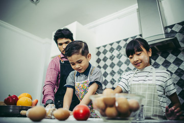 Happy family cooking together in the kitchen at home. Family concept.