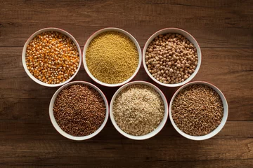 Foto op Plexiglas Whole foods diet base - various seeds in bowls on brown table © Arpad Nagy-Bagoly