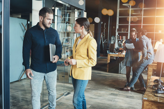 Discussion meeting in open space office. Teamwork business concept. Four people