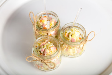 Russian salad in the glass can