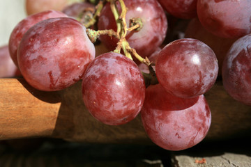 Bunch of grapes on a wooden table an old, country house. An element of outdoor decoration on the...