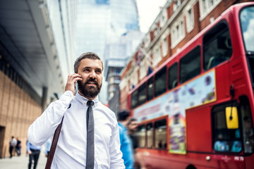 Homme d& 39 affaires hipster dans la rue à Londres, passer un appel téléphonique.