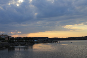 mediterranean village of Guissan and marine pond at sunset  , Aude in the south of France

