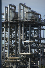 pipes machinery and wind turbine at plant