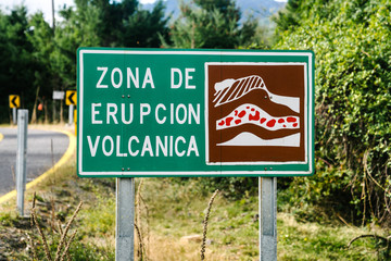 "Volcanic Eruption Zone" street sign in Spanish where lava is likely to flow during an eruption in Chile