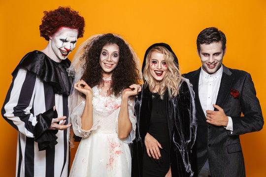 Group of happy friends in scary costumes