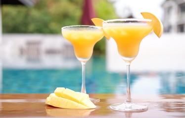 mango margarita cocktail at swimming pool