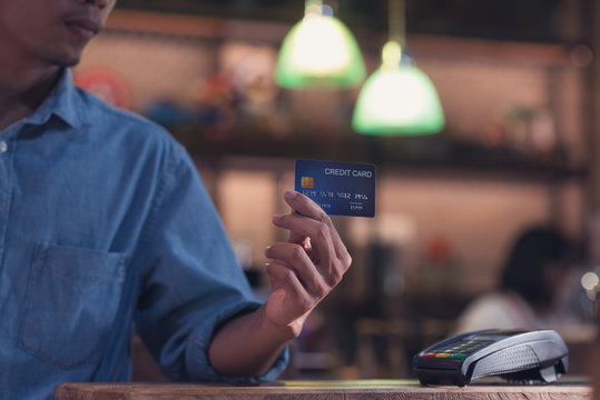 Credit card payment, Hand of male paying with a credit card reader machine