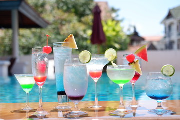 classic summer drinks and cocktails at swimming pool