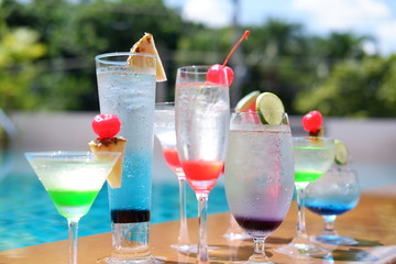 classic summer drinks and cocktails at swimming pool