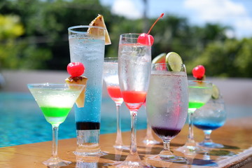 classic summer drinks and cocktails at swimming pool