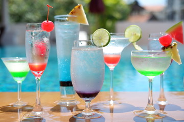 classic summer drinks and cocktails at swimming pool