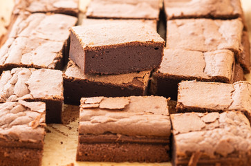 Homemade brownies with dark chocolate on a paper background. Overhead shot.