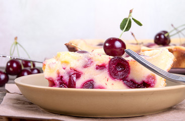 Piece of sweet cherry clafouti. Summer pie.