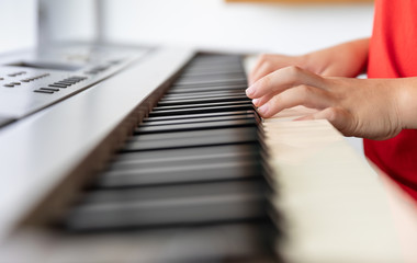 Fototapeta premium children playing piano classical close up on hand 