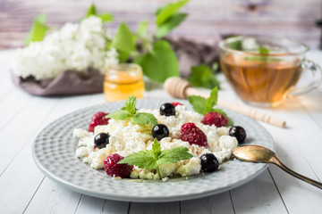 Russian cottage cheese with berries, honey mint, selective focus, healthy Breakfast