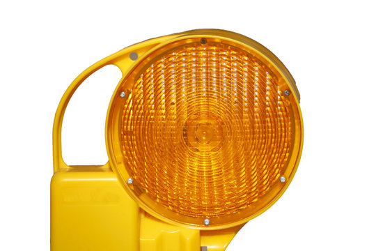 Orange Baustellenlampe an einer Baustellenabsperrung