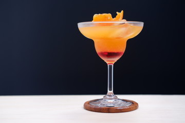 orange margarita on wood table