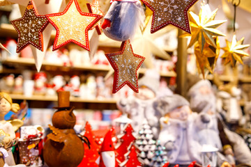 Different decoration, toy for xmas tree on christmas market, close up of cozy handmade gingerbread stars