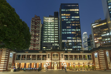Old and modern high rise buildings in Hong Kong city at night