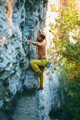 rock climbing. man rock climber climbing the challenging route on the limestone wall