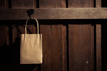 Shopping bag hanging on the wooden wall