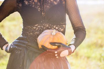 woman holding a pumpkin in her hand