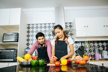 Happy couple cooking together in the kitchen at home. Couple concept