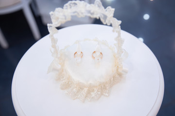 Gold wedding rings on the stand for rings