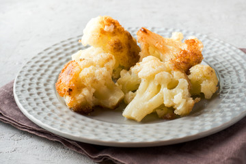 Florets of cauliflower batter fried in oil on the plate