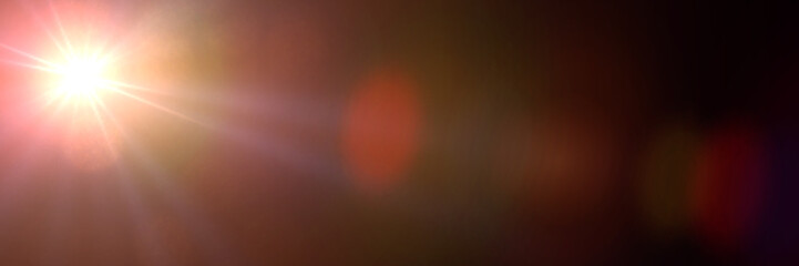 golden screen lens flare effect overlay texture in shades of orange and red with bokeh in front of a black background banner - obrazy, fototapety, plakaty