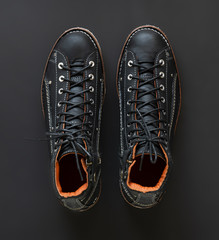 Men’s black ankle boot with zipper isolated background. top view