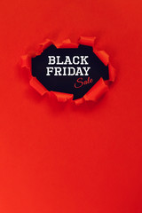 hole in red paper. text black friday sale. copy space