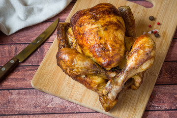 Heavily roasted grilled Chicken on wooden background
