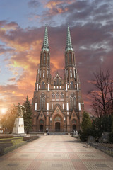Twin Towered Cathedral of Saint Michael the Archangel and Saint Florian the Martyr in the Praga District of Warsaw, Poland at sunset - obrazy, fototapety, plakaty