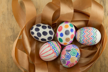 colorful easter eggs on gold ribbon