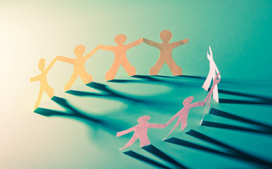 Paper people in teamworking concept.