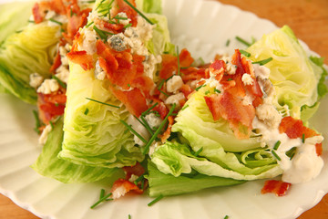 Iceberg lettuce with bacon, blue cheese dressing and chives